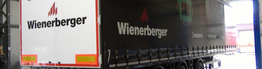 Printed truck with hands holding a brick, roof tile and clay block