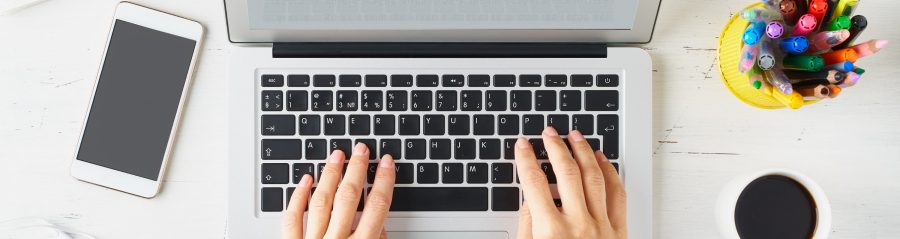 Work from home, online shopping, learning. White desk, old table. Top view. Distance education. Woman hands typing on laptop. Freelancer, Digital nomad concept