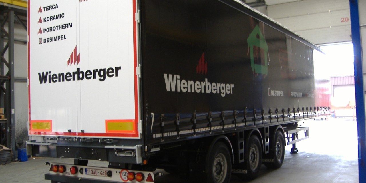 Printed truck with hands holding a brick, roof tile and clay block