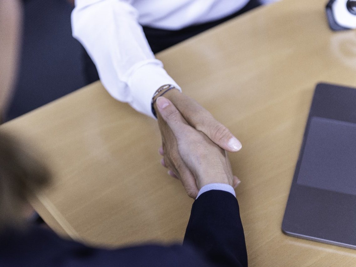 Handshake at conference table, sales, project management, Fast Forward Procurement