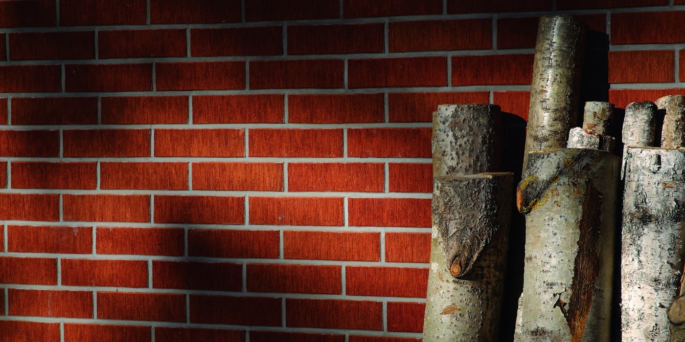  Some firewood in red brick wall background